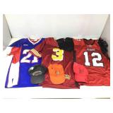 Assorted sports shirts and hats
