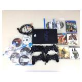 PS2 with assorted Playstuon Games and controllers