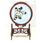 Hand-embroidered silk panda bears wooden table