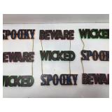 Pink dog plush and 3 Wicked Spooky Beware decor