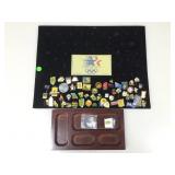 Board display with collection of pins. Olympics