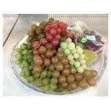 Artificial grapes, faux fruits on plastic platter