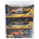 3 hot wheels delux model race cars in box. Pop