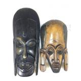 2 carved wood tribal mask style faces.