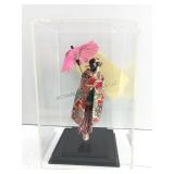 This item is a Japanese geisha doll enclosed in a