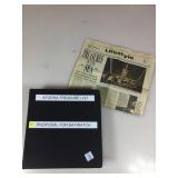 Black binder and large folder containing Hawks