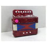 Small Bakelite miniature accordion with seven