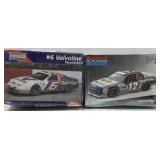 One lot with two model race cars still wrapped in