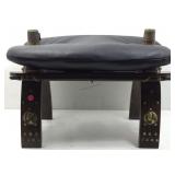 This vintage style camel saddle stool features a