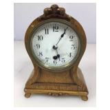 Small round top oak and brass mantle clock