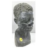 This image shows a gray stone bust sculpture