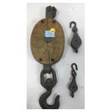 Three vintage overhead pulleys one large with