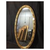 Oval mirror in carved gold frame. 19 X 36 inches