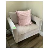 Grey armchair w/metal legs and pink pillow,