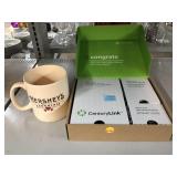 Wireless modem in box and Hershey chocolate mug