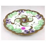 An antique hand painted porcelain cabinet plate