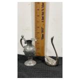 Silver color.  Metal vase and swan