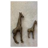2 solid, brass giraffes