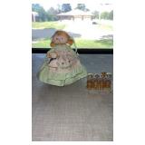 Many refillable, perfume bottles, and cloth doll