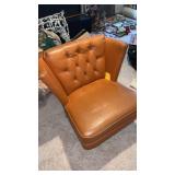 Mid century burnt orange swivel chair in