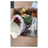 Box of artificial flowers and Christmas bulbs