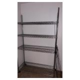 Metal rolling rack on wheels. . Approximately  76
