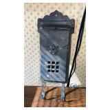 Cast iron wall mount mailbox with newspaper