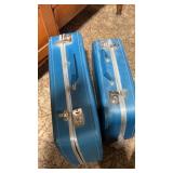 2 blue hard case suitcases