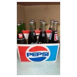 8 ok of miscellanious sodas bottles all are
