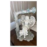 Angel on a swing statue . Plastic approximately