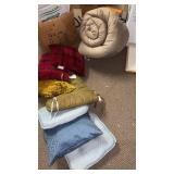 Decorative pillows,  sleeping bag and chair