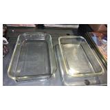 2 clear glass baking dishes. 1 is Pyrex