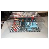 Diorama of a car being  worked on in a garage