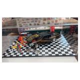 Diorama of a car being  worked on in a garage