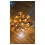 Gold tone napkin rings, and a candle snuffer