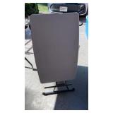 Small white folding table and garbage can