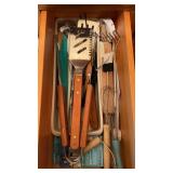 Group of grilling utensils including tongs and