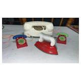 Collection of vintage toy phones, and toy iron