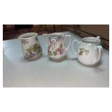 3 porcelain toothpick holders with floral design.