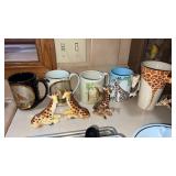 Coffee cups with giraffes on them and giraffe