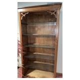 ighted wooden book shelf with glass shelves