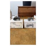 Two pewter small collectible tractors, one case