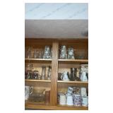 Cupboard of miscellaneous coffee cups and more