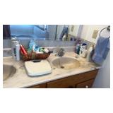Bathroom with lots of miscellaneous soaps ,