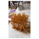 Lot of orange depression glass glasses and fruit
