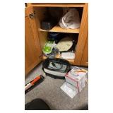 Contents of cabinet: steak knife set, slow cooker