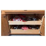 Contents of both shelves in cabinet: various pots