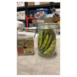 Mason jar with plastic snow peas inside and match