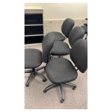 4 Black Cusioned Office Chairs on Casters