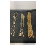 3 gold tone womanï¿½s necklaces.  1 is Victoria
